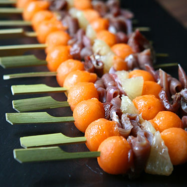 Skewer of melon, smoked duck breast and Pink Grapefruit
